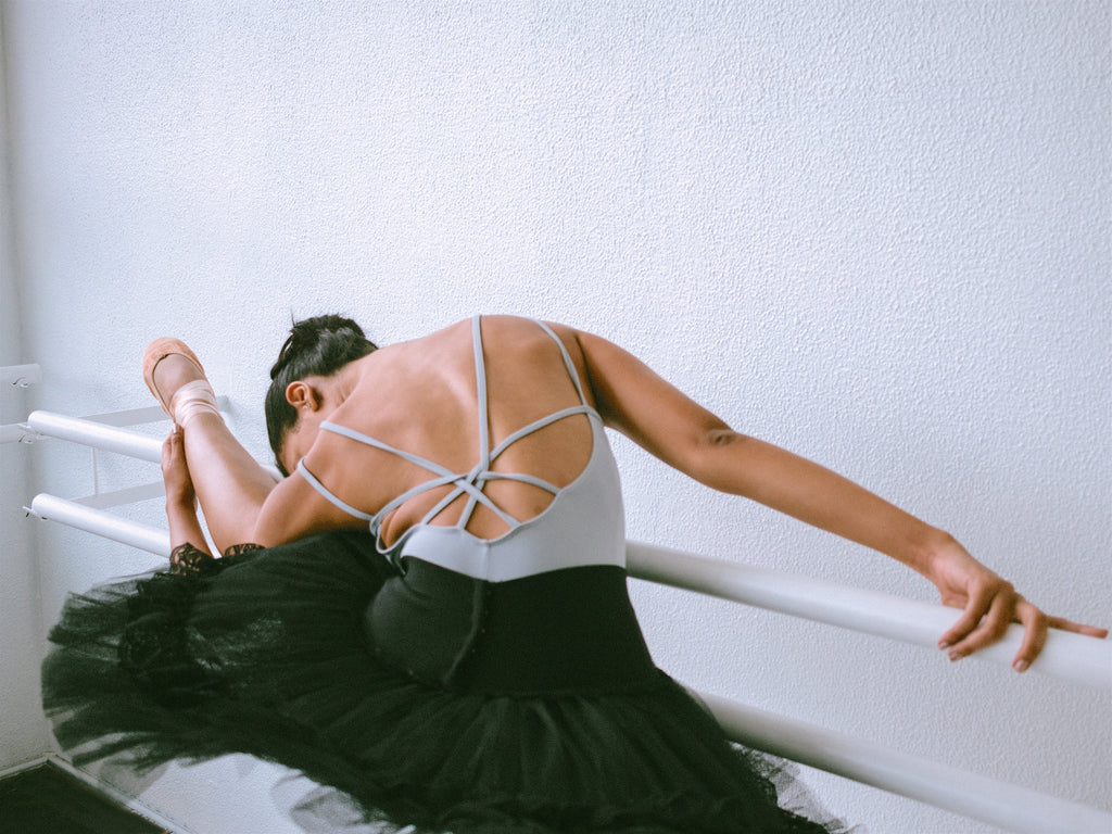 Dancer in Blue Leotard and Tutu, with Leg on Barre in Hamstring Stretch